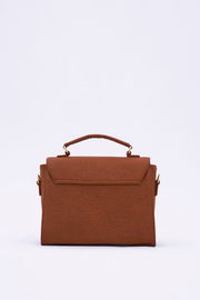 A small, brown rectangular handbag with a top handle, crafted from Piñatex® vegan leather alternative, photographed against a plain white background is the London LHR - Piñatex® Saddle Bag - Mocha by 1 People.