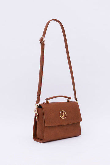 A London LHR - Piñatex® Saddle Bag - Mocha by 1 People made from vegan leather alternative with a front flap featuring a gold logo, a top handle, and an adjustable shoulder strap.