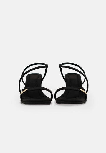 Pair of black strappy heeled sandals with thin straps and a central heel rest against a white background. The **Vegas LAS - High Heels - Onyx** by **1 People** feature Zahonero Comfort Insole, providing all-day support, and Eco Suede material for an eco-friendly touch.