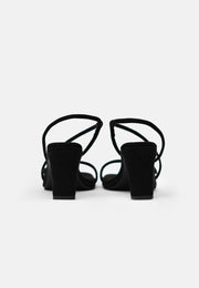 A pair of 1 People Vegas LAS - High Heels - Onyx with low, square recyclable plastic heels viewed from the back on a white background.